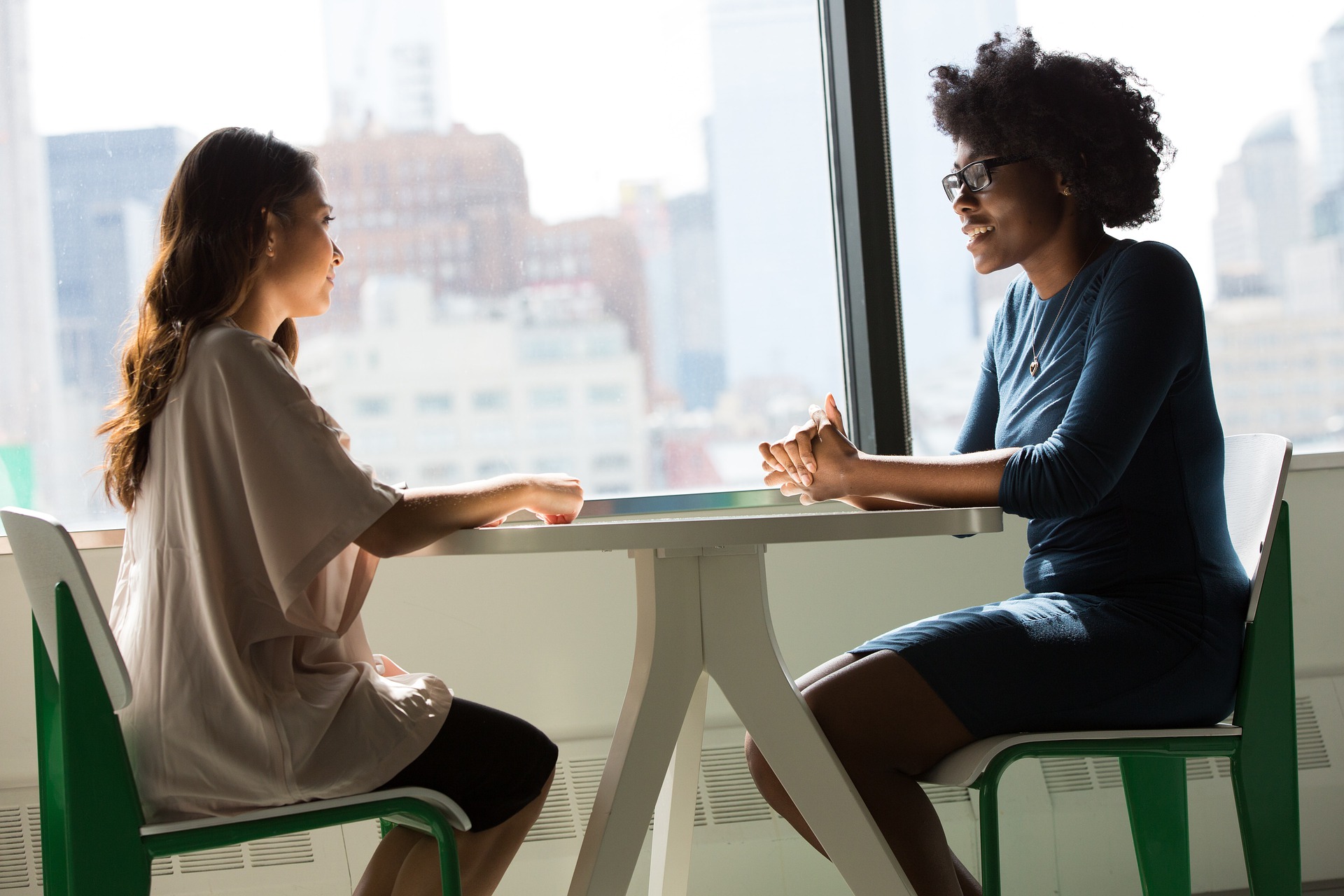 Two people sitting at a table talking