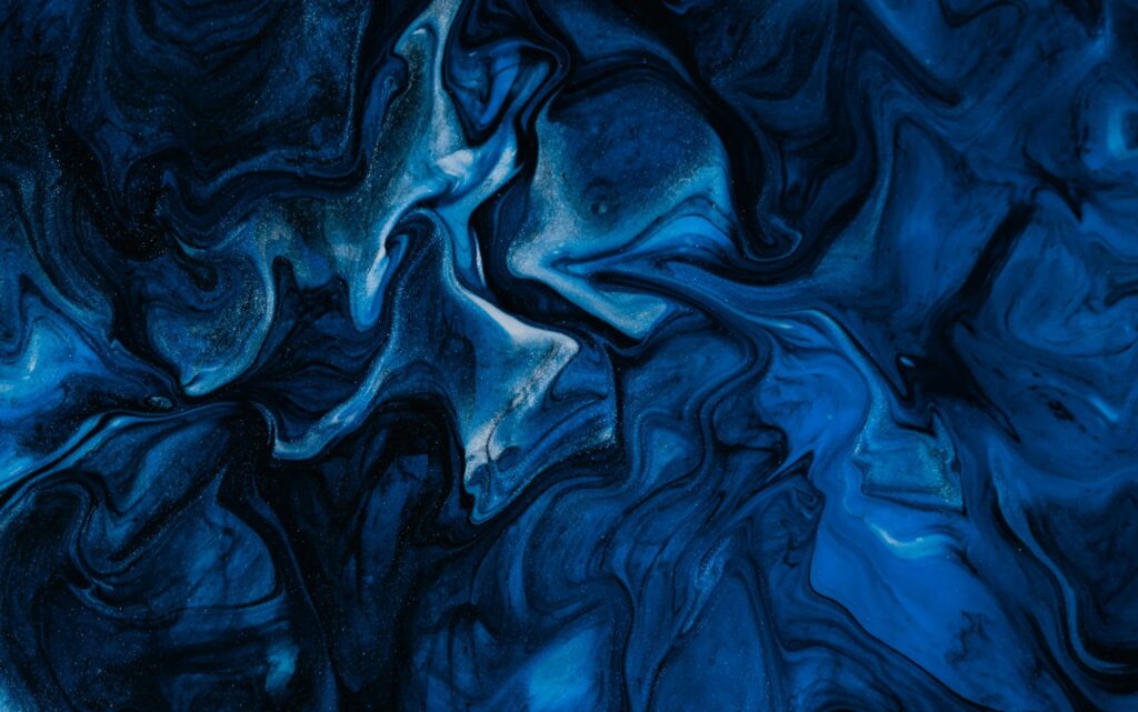 Abstract blue and black marbled pattern with flowing organic shapes that resemble currents, ink, or natural networks.