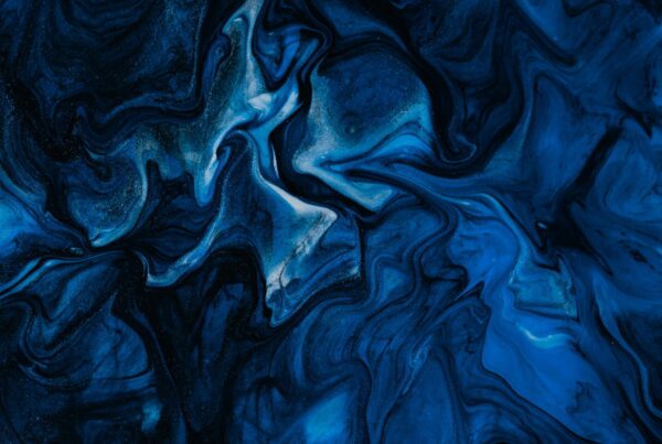 Abstract blue and black marbled pattern with flowing organic shapes that resemble currents, ink, or natural networks.